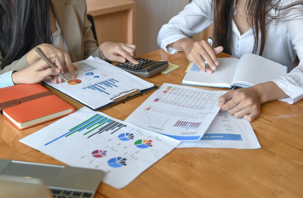 female office staff team summarizes the budget for the annual executive presentation.