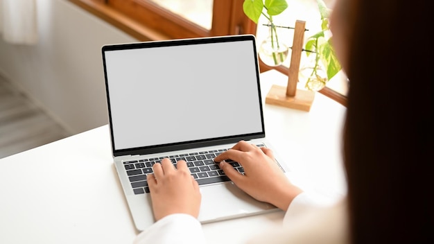 Female officer or businesswoman working on laptop computer typing on keyboard