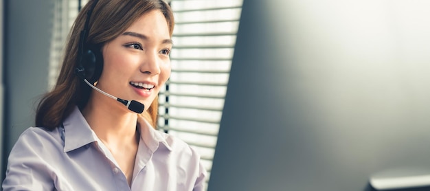 Female operator working on computer and while talking with cordial clients