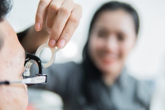 A female ophthalmologist on a trial frame when with the patient in the clinic