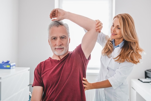 Female orthopedist examining patient in hospital