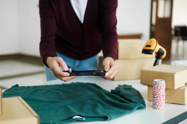 Female owner taking pictures of online product