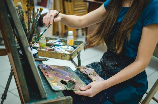 Female painter drawing in art studio