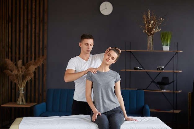 Female patient doing physical exercises with physiotherapist.