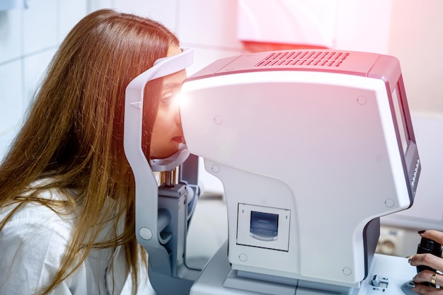 Female patient having her vision checked Medical ophtalmology equipment Diagnosis