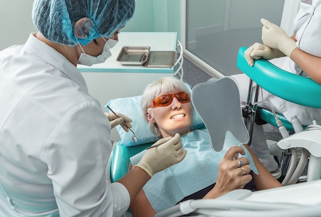 Female patient receiving treatment from dentist.