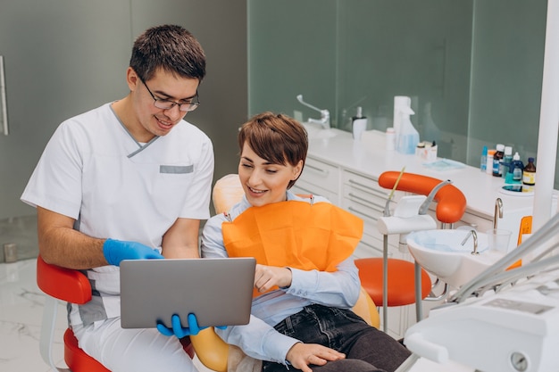 Female patient sitting in a dentist chair and making professinal hygiene