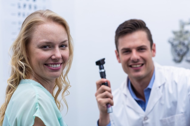 Female patient smiling with optometrist in background