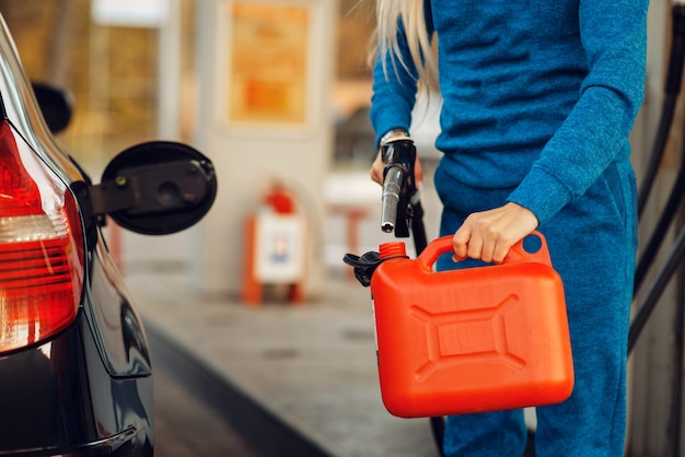 Photo female person filling canister on gas station, fuel refill. petrol fueling, gasoline or diesel refuel service, petroleum refueling