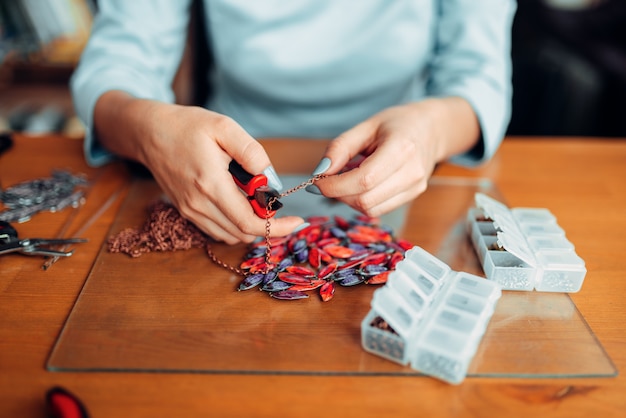 Photo female person hands with pliers, master at work.