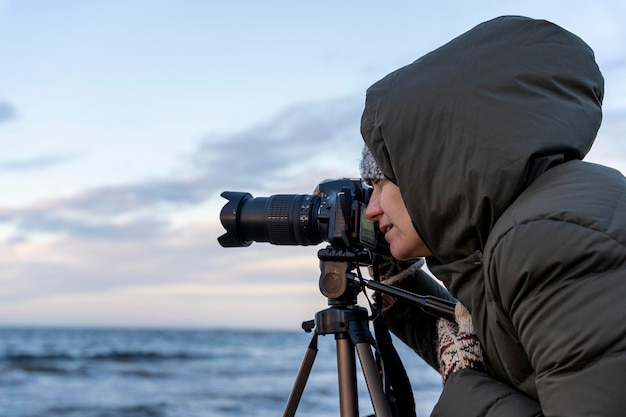 Female photographer takes pictures with a camera