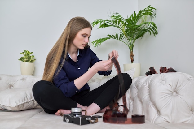 Female photographer with photographic films and vintage film camera