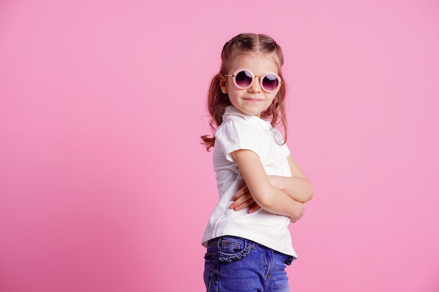 female in pink round sunglasses isolated on pink