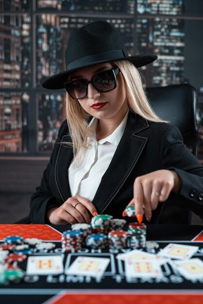 Female player sitting a table at a casino and play poker jackpot Gambling