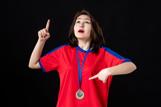 Female player with gold medal on black