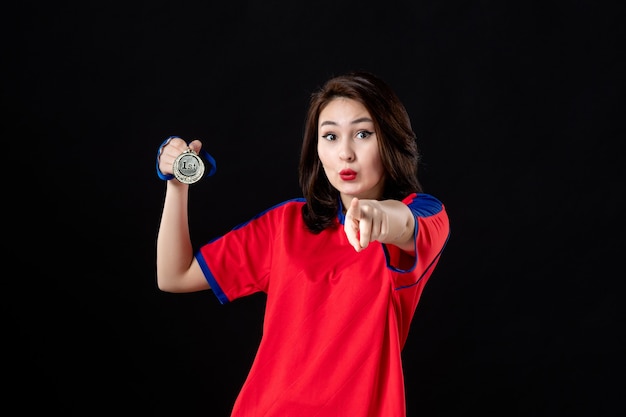 Female player with gold medal on black