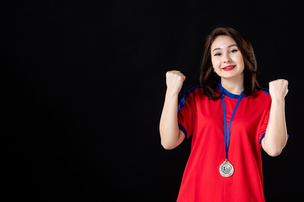 Female player with gold medal on black