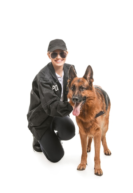 Female police officer with dog on white