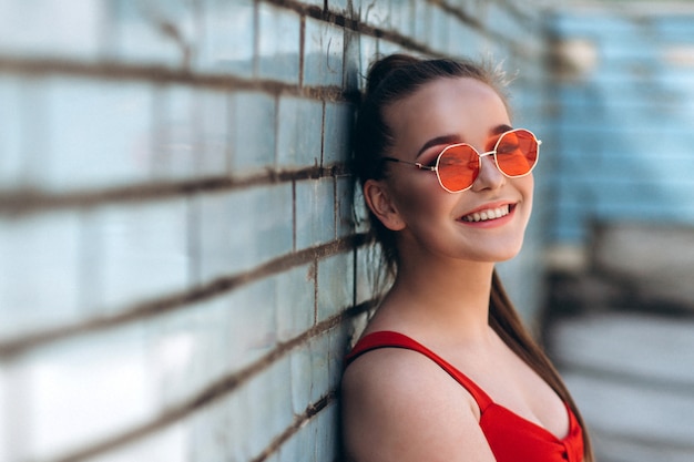 Female portrait in red sunglasses outdoors