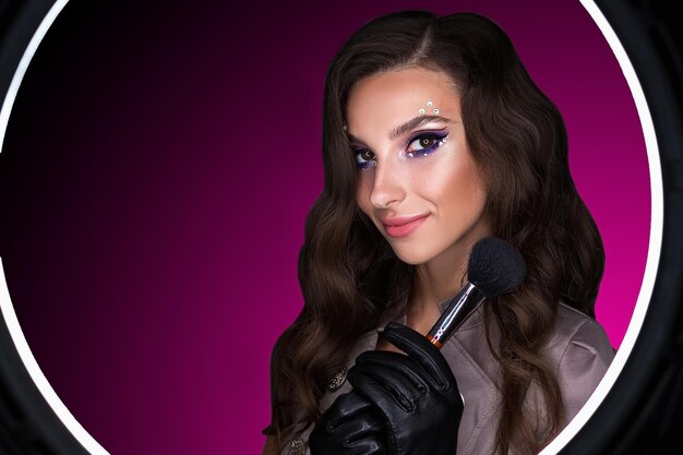 female portrait of a young brunette girl with a beautiful evening makeup the girl has gloves on her
