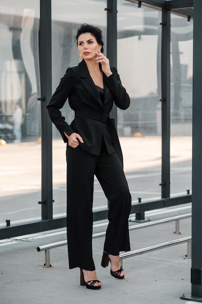 Female posing in pantsuit outdoors and looking at camera