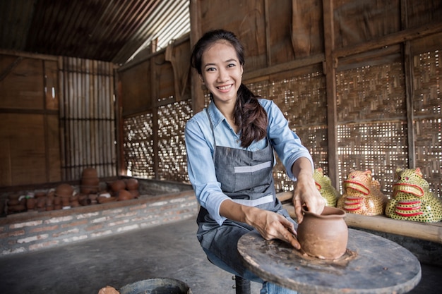 Female potter making pot