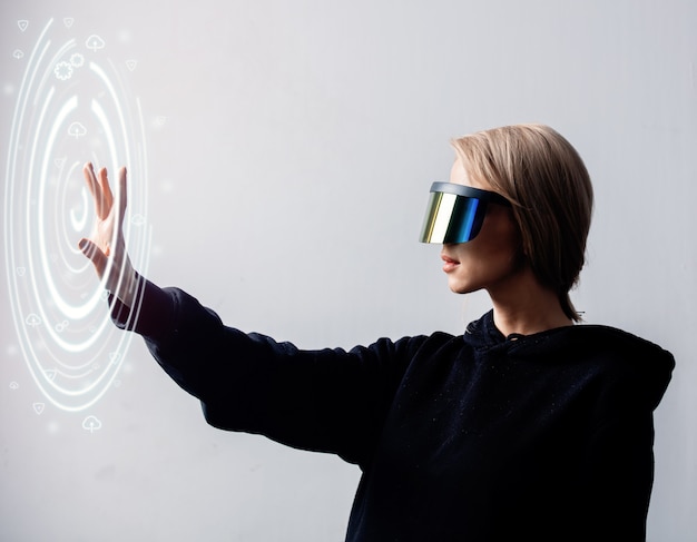 Female programmer works with personal data in virtual glasses