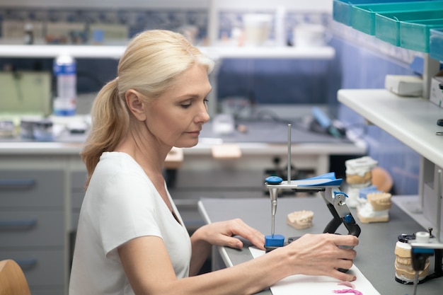 A female prosthetist working with plaster prosthesis