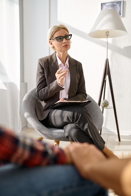 Female psychologist talking to couple at consultation