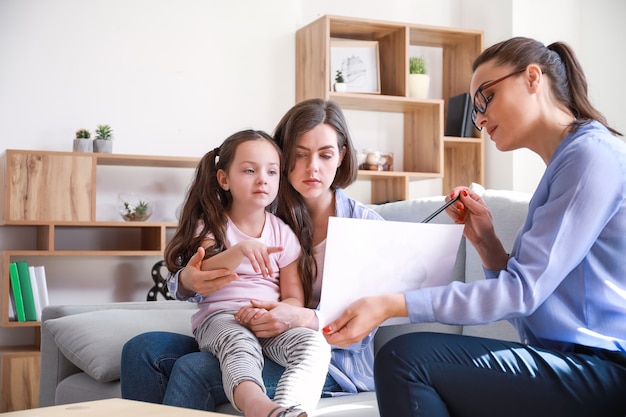 Female psychologist working with family in office