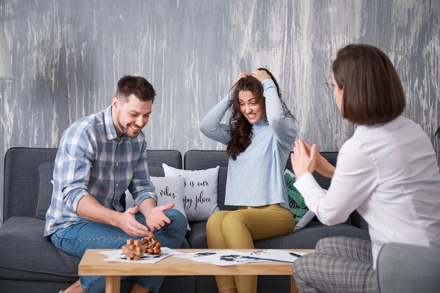 Female psychologist working with unhappy couple in office