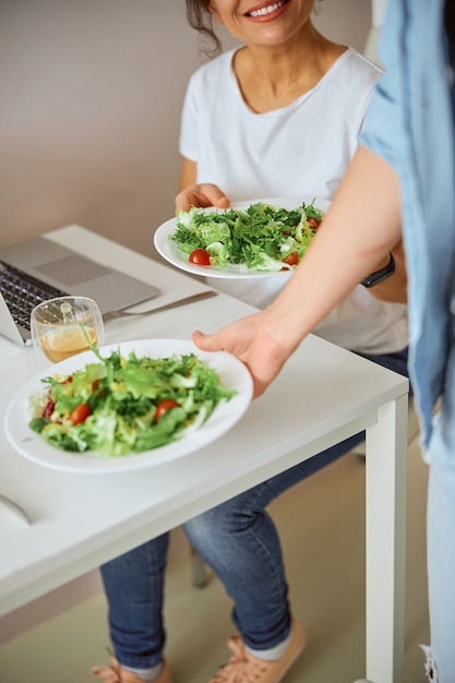 female putting plate on table