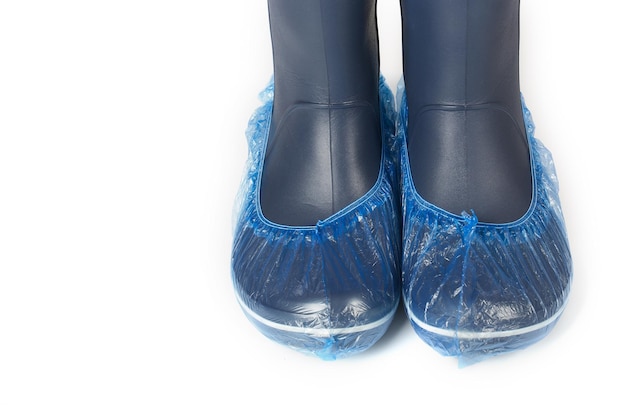 Photo female raining shoes in disposables shoe cover. closeup.isolated over white.