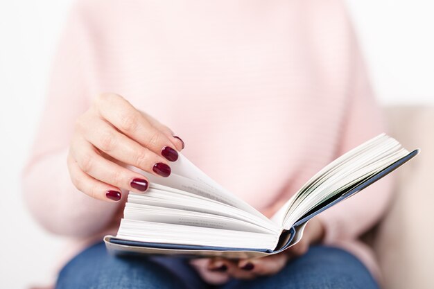 Female reading book in home