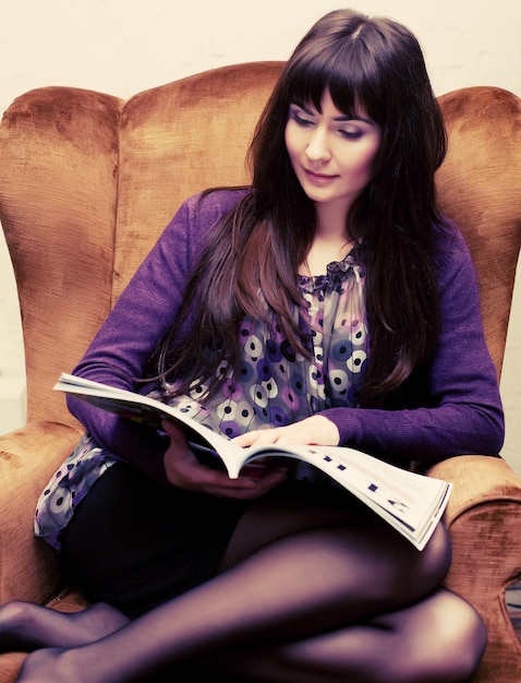 Female reading a magazine at tea time