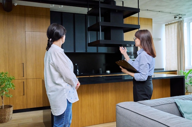 Female real estate agent showing apartment house to buyer tenant