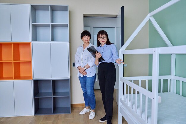 Female real estate agent showing apartment house to buyer tenant