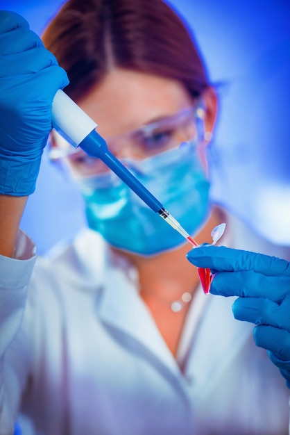 Female researcher using micro pipette