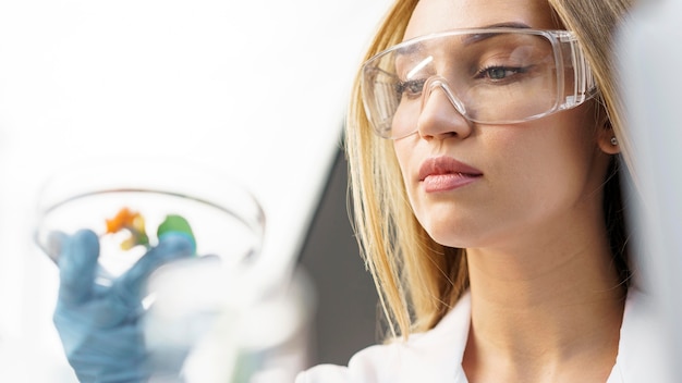 Photo female researcher with safety glasses in the lab