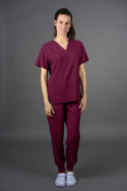 Female resident doctor posing in purple nurse39s scrubs