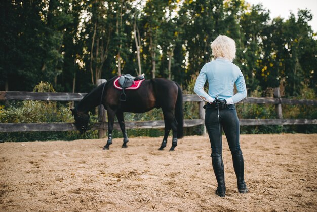 Female rider trains her horse, horseback riding