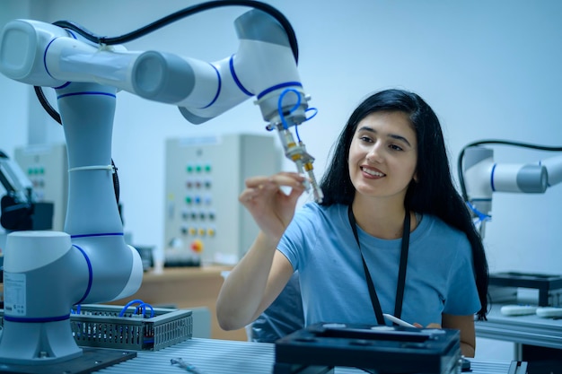 Female Robotics engineer working with Programming and Manipulating Robot Hand