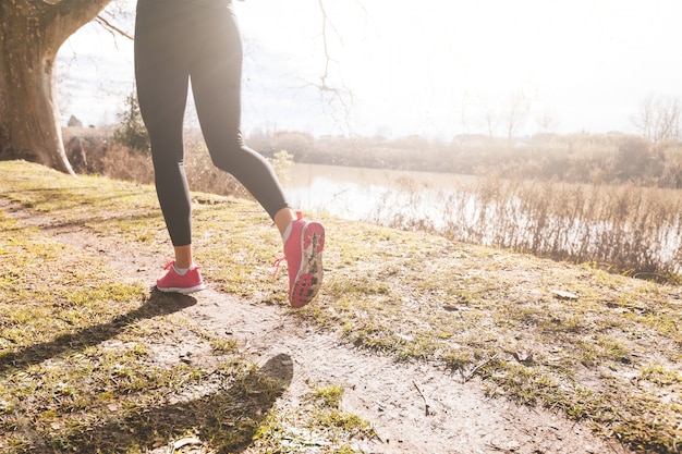 Female Runner Legs Closeup on Off Road Path. 