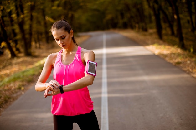 Female runner during outdoor workout in beautiful autumn mountain nature landscape