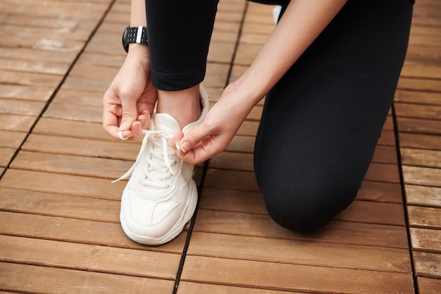 Female Runner Tying Shoe Laces