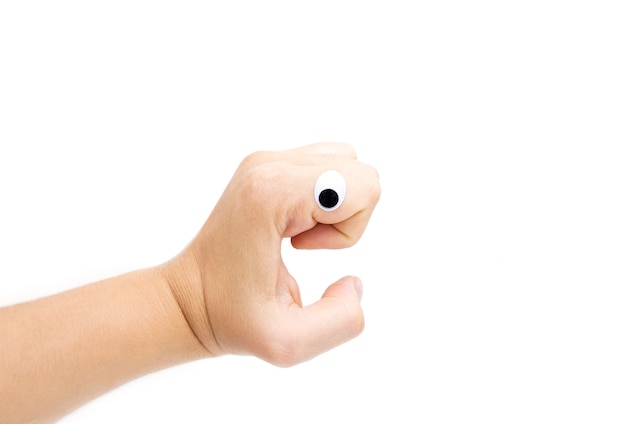 Female's hand with plastic eyes on white background