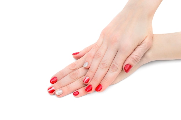 Female's hands with red manicure on white background