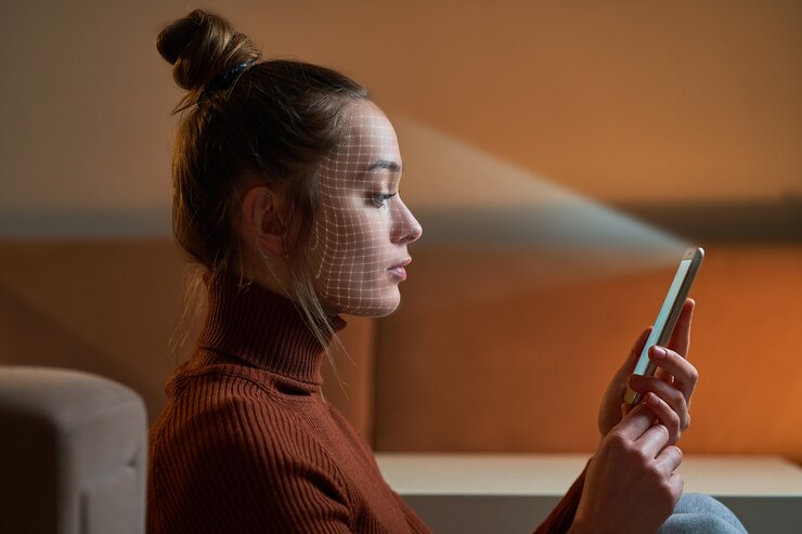 Photo female scans face using facial recognition system on smartphone for biometric identification. future digital high tech technology and face id