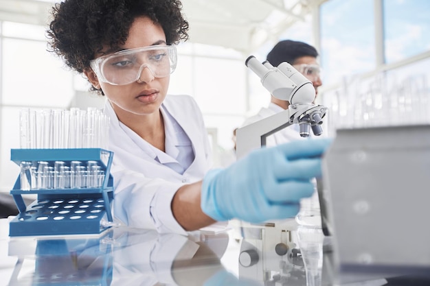 Female scientist and her colleagues work in a medical laboratory