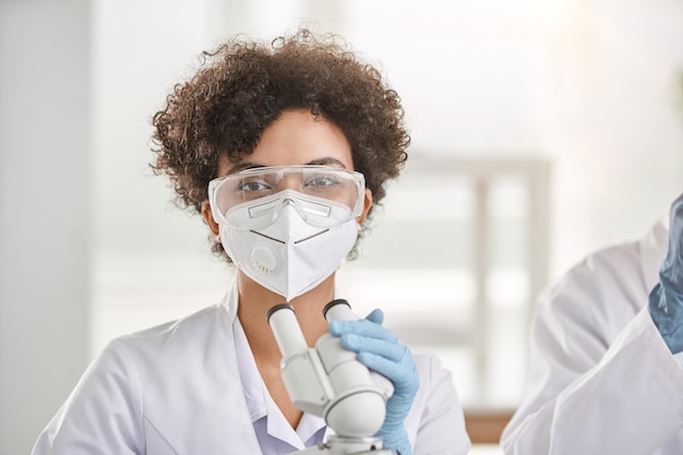 Female scientist sitting at a laboratory table